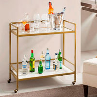 Serve up some fun with the Lionel Bar Cart. This two-tier serving cart, from Martha Stewart, has a metal frame with an antique gold finish, a tempered glass top, and a white ceramic bottom shelf. 