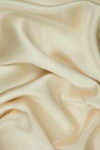 Mother Of Pearl Silk Crepe Back Satin Fabric is a lighter medium weight, shiny fabric with a similar look and drape to charmeuse. Distinguished by its luxurious design, this high-quality fabric is perfect for eveningwear, bridal/wedding, and lingerie. The face side of this fabric features a glossy satin finish while the back has a traditional pebbly crepe texture. Our unique and distinctive fabric is available in a wide selection of colors. The fabric is sold by the Yard, and measures 44 inches