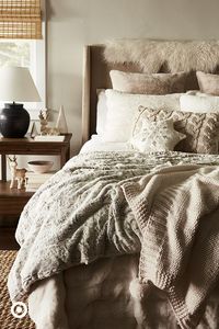 Up the cozy factor in your bedroom with layers of faux fur and soft knits. Pile on throws and toss pillows and even go for faux-fur pillowcases.