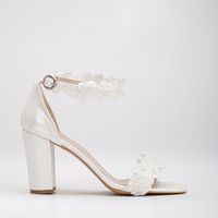 Congratulations on your big day! These Ivory Block Heel Wedding Shoes from Forever & Always Shoes are perfect for any bride. With a low heel height of 3.7 inches (9.5 cm), they offer both style and comfort. These wedding sandals feature a front strap and an adjustable ankle strap with a buckle, both adorned with delicate flower-shaped tulle material that adds a touch of elegance to your bridal look. Crafted with care, these bridal sandals are designed to make you feel comfortable and confident o