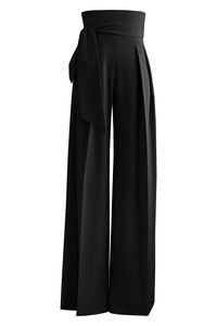 L’MOMO women’s pants. Emphasize your divine stature with these chic palazzo pants. The snug fit at the waist creates a streamlined silhouette accented by flowy ribbon ties. The wide-leg style with structured pleats magnificently highlights your elegance. Match this pair with a trendsetting top for an eye-catching look. Zipper Closure Stretch Included Eco-Friendly Made Fabric 97% Polyester, 3% Polyurethane Care Delicate wash 35°C / 95°F or dry clean. Do not bleach. Do not tumble dry. Low iron. Made in Canada from Imported fabric