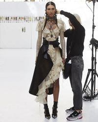 A silk knit dress with laddered ruffle trims and lacing details, worn with an asymmetrical draped belt. Photographed by Sir Don McCullin before the Spring/Summer 2019 show in Paris.