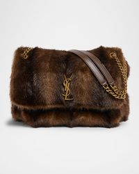 "Find SAINT LAURENT Niki Faux Fur Shoulder Bag on Editorialist. The Saint Laurent Niki shoulder bag is crafted from lamb leather and faux fur. The bag features a signature YSL logo accent, sliding chain/leather shoulder strap, and a flap top with a magnetic closure. The bag also includes an exterior slip pocket under the flap, gold tone hardware, and professional cleaning is recommended. The bag measures 9.1\"H x 12.6\"W x 3.5\"D. This bag is made in Italy."