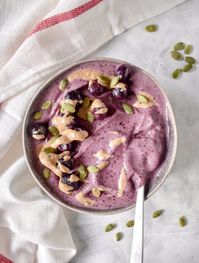 This blueberry smoothie bowl is deliciously thick and creamy. Drizzle with almond butter for a nutritious snack! This smoothie bowl is vegan and dairy-free.