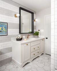 We used a classic subway tile for the walls in the bathroom, but instead of just using one color, we created a striped design using grey and white. The end result was a really cool feature that made this bathroom really unique.