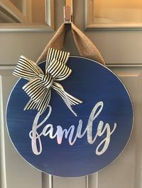 18” wood round door hanger - approx 1” thick. The burlap hanger is about 6” long. Wood round is painted blue with metal family ***BOW may vary depending on ribbon availability. If an exact bow choice is preferred, please contact us before ordering Each door hanger is made to