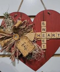 "Sweet Heart" is speed with scrabble tiles on a hanging wooded Valentine heart.