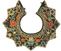 China | Silk and gold collar with applied varied jade ornaments, malachite, amber, carnelian, kingfisher, rubies and amethysts. | Late Ching period.