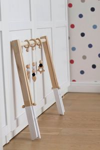 A beautiful 100% handmade wooden baby gym that is perfect for your baby's first months of exploring the world. Frame is made from alder wood and not treated with any oils. Ours baby gym is very stable, strong and sturdy. The alder wood gives the stability and reliability, as well as very beautiful natural coloration of the wood. We are only using paints which is suitable for toys(water based, acrylic). If requested, we can paint top and/or bottom of the frame in your chosen color. If you can't f