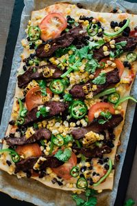 This delicious Taco Pizza with Carne Asada and Roasted Corn is a fresh and innovative new way to enjoy your favorite Mexican beef dish. It's sure to satisfy your taco and pizza cravings all in one!