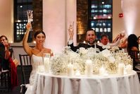 Cheers to The Newlyweds! Loved this Combination of Baby's Breath and White Roses for their Sweetheart Table! The Candlelight is Everything! A Mixture of Hurricane Candles and Votives always Creates such a Beautiful Tablescape.