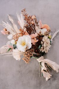 Create a stunning DIY boho wedding bouquet with dried flowers from Afloral.com. #driedflorals #weddingbouquet #bohobouquet