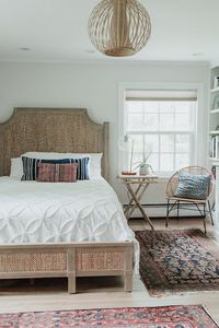 coastal bohemian bedroom with vintage rug and rattan bed