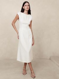 We reimagined the classic shift dress in a luxurious certified European linen, a fabric we love for its lived-in look and its ability to stay cool and crisp even in heat and humidity.  Here, we added subtle cap sleeves and darts to shape the waist for an almost corset-like silhouette.  Fit and flare.  Crew neck.  Invisible zip at back.  Unlined.  Fit and flare.  Short sleeves.  Midi length.  Model: Size 2, 5'10" (178cm).