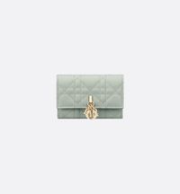 The My Dior Glycine wallet is distinguished by its compact and practical design. Crafted in pistachio green Cannage lambskin, it is enhanced by D.I.O.R. charms on the front. Accommodating all the essentials, the refined accessory will fit anywhere and can be paired with other My Dior creations..