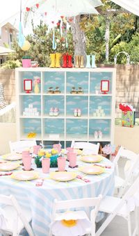 Adorable baby shower decor with baby bottles and tiny rainboots.