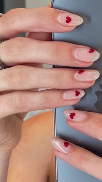 15 pretty and chic Valentine's nail ideas to try. We have rounded up lots of Valentine's Day nail ideas. From pink and red nails, to nails with heart designs we have you covered! Red nails, pink nails, heart nails, valentines day nails, Febuary nails, valentines day nails acrylic, trendy nails, nail trends.