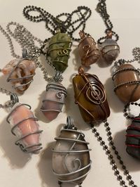 These impressive hand wrapped pendant necklaces are sure to delight with their unique shapes & color combinations. Aside from #2 & #10, the pendants are agates. They can easily be taken off the chain they come with and put on your favorite necklace chain. They will undoubtedly add a new dimension to any outfit. I collected the rocks walking the shores of Lake Superior and then tumbled and polished them before hand wrapping them in wire.