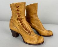 These stunning Edwardian boots will bring your wardrobe game to the next level!  The leather is a beautiful and unique ochre with a cap toe with broguing and the top has a slight arc in the front. It fastens with fourteen buttons and has a leather sole and comfortable stacked heel. Canvas lined. Labeled "Select Circle". These boots are in great deadstock vintage condition with no wear to the soles! We estimate these to be a US 7 (we're confident the 7 in 8774 notes the size), please go by measurements for accuracy.  Measurements: Insole Length: 9" Outsole Length: 10" Outer Width: 3" Heel Height: 2" Find our other vintage splendid shoes here: https://www.etsy.com/shop/OverAttiredVintage?section_id=19096587  Within the US, we ship our shoes in padded flat rate envelopes. If you would prefer