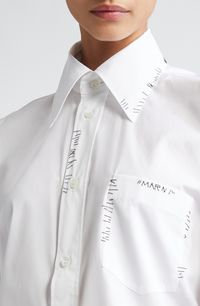 Hand-stitched 'mending' imparts a quirky, homespun character to an otherwise prim poplin shirt with an exaggerated point collar. Front button closure Point collar Short sleeves Chest patch pocket 100% cotton Dry clean Made in Turkey Designer Clothing