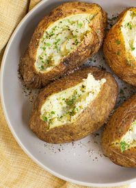 Making the perfect crispy skin, baked potato can be a bit of a challenge. However, I have found the secret to perfect baked potatoes every time! This air fryer baked potatoes recipe makes a light and fluffy inside and a crisp salty outside every time. They make a great side dish or bake a large one and make it a meal with toppings like  copycat Texas Roadhouse chili or  roast beef and gravy. Why cook a baked potato in an air fryerUsing this air fryer recipe you will get one of the b…