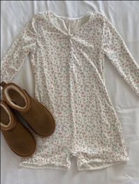 Experience relaxation and style with our Blossom Floral Cotton Pajama Bodysuit. Crafted from 100% cotton, this cozy bodysuit offers the perfect blend of softness and breathability, ensuring a restful night's sleep or lounging in comfort. The exquisite blossom floral pattern adds a touch of elegance, while the stretchy design and convenient snaps make it easy to wear. Upgrade your bedtime routine with this chic and comfortable Blossom Floral Cotton Pajama Bodysuit, perfect for lazy days and laid-