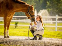 Flex fence in background- captured is a girl and her horse having a beautiful moment