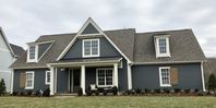 Roycroft Pewter Siding; Natural Choice trim; Caribou front door; Bronze metal roof; Weathered Wood shingles; White windows; Harbor Mist stained shutters