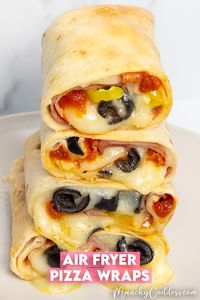 Pizza wraps filled with pizza sauce, ham, melty mozzarella cheese, pepperoni, banana peppers, and black olives.