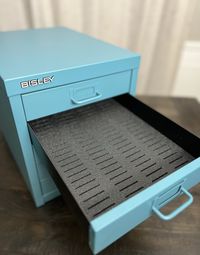 A perfect addition to the Bisley cabinet. Designed to hold 108 floss bobbins in each drawer. Each insert is roughly 9.25" x 14" cut to fit inside the drawer. Two different styles available. Each style accommodates 108 floss bobbins. The thin slot is designed to hold the thin plastic DMC bobbins or the cardboard style bobbins. These are typically found at your local craft store.  The larger slot is designed to hold the thicker acrylic bobbins. This design will accommodate bobbins  1.5mm to 3mm th