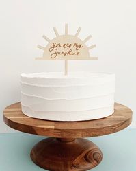 "\"you are my sunshine\" Cake Topper | Pictured: Etched thin natural birch wood This cake topper is hand lettered, digitized, and then laser cut *Sizing: 5 inches wide *Made of either 1/8\" thick Natural Birch Wood *Stick of cake topper is about 4\" tall *Cake topper is best for 5-8\" wide cakes, but will look great on all sizes :) PROCESSING TIME + SHIPPING TRANSIT TIME *PROCESSING TIME - it will take anywhere from 2 to 5 business days to MAKE this item *SHIPPING via USPS First Class Mail (Free