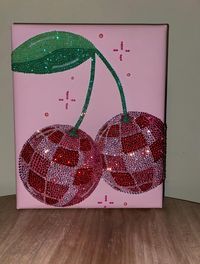 Introducing a dazzling piece of art: the Cherry Disco Ball Handmade canvas. Each rhinestone is meticulously placed by hand, creating a stunning visual effect. This 8x10 canvas is ready to mount and adds a touch of sparkle to any space. Crafted to order, please allow 1-2 weeks for this unique creation to arrive at your doorstep.