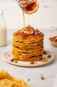 These fluffy pumpkin pancakes are the perfect fall-inspired breakfast. They're easy to make, require minimal ingredients, and are ready to eat in under 30 minutes. Sweeten up your breakfast and brunch with this seasonal recipe. #vegan #recipe #pancakes #fall #seasonal #autumn #brunch #breakfast #plantbased #dairyfree #sweetsimplevegan