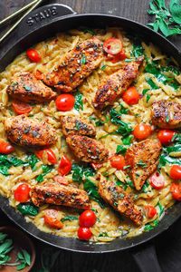 Creamy Chicken Orzo with Tomatoes and Spinach - in a cast iron skillet.