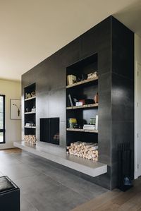 modern fireplace, Neolith porcelain fireplace, feature fireplace, large fireplace, fireplace with built-in shelves, recessed shelving, built in shelving, barn wood shelves, concrete fireplace, Dos Gatos, Michigan, Beth Howley Creative, #bethhowleycreative #signatureenvironments