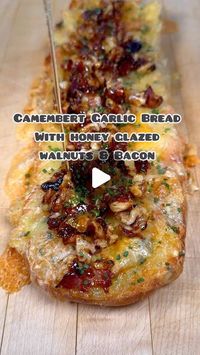 Sam Stern on Instagram: "Camembert garlic bread with honey glazed walnuts and bacon. 
I think we can all agree that garlic bread is the best thing ever. Add some camembert and it gets better. Top all that with a sweet, salty and crunchy walnut and bacon crumb? Even better. Who wants it?
Recipe:
1/2 large ciabatta 
50g soft salted butter 
2-3 cloves garlic, crushed 
A handful of parsley, roughly chopped 
Seasoning
1 250g Camembert, fridge temp. 

4 slices streaky bacon 
a large handful of walnut halves, cut into small pieces 
1/2tsp chilli flakes 
2-3 tbsp honey 
Chives, finely sliced 

1. Preheat the oven to 180c fan. 
2. Combine the butter, garlic, parsley and seasoning. Spread this over the ciabatta half. 
3. Remove the top and bottom rind from the Camembert if you want. This isn’t essen