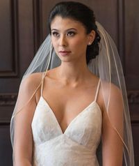 This simple fingertip length wedding veil is both understated and sophisticated. The raw edge design makes this wedding veil a romantic accessory that compliments many silhouettes and styles of wedding dresses. A meticulously handmade bridal veil for the classic, elegant bride. FREE garter with every veil purchase!