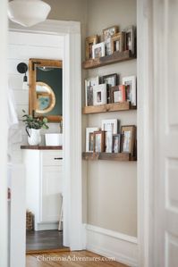 Easy DIY picture ledge - a great way to decorate a narrow hallway. This is a flexible alternative to a gallery wall!