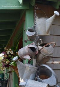 Hang a collection of watering cans to decorate a garden shed or front porch.