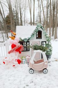 Playhouse decor for the winter months. Holiday balloon arch and cozy coupe makeover with tree on top