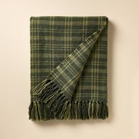 Add holiday warmth to your decor with this Chunky Christmas Plaid Woven Throw Blanket from Hearth & Hand™ with Magnolia. This midweight throw blanket is adorned with a tonal green plaid pattern on a dark green background, and it features fringed ends for a playful look. Ideal for draping over a chair or sofa or spreading on your bed, this chunky blanket adds a cozy, stylish layer to any space. Hearth & Hand™ with Magnolia: Gather • Create • Enjoy