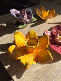 Handmade ceramic candle holder, made in the shape of a yellow daffodil flower.