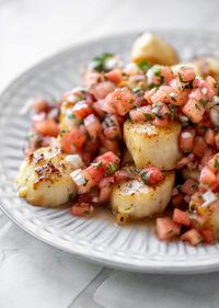 Garlic butter scallops that melt in your mouth topped with refreshing and flavorful watermelon salsa created the perfect summer dish!  It’s slightly sweet, a little spicy and the perfect crunch on top of the buttery scallops! howsweeteats.com