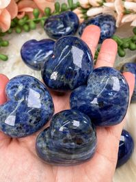 Stunning and unique blue sodalite hearts with an amazing shine! These sodalite puffy hearts are nearly an inch thick, so when I say puffy, I mean it! They all have an overall blue coloring, but the shades of blue will vary, some have whites or grays mixed in, some even have some metallic specks of either galena or pyrite. These sodalite hearts are intuitively chosen, but they are all awesome in their own way! Approx. 1.75" in size. .75" thick! You will receive ONE Sodalite heart that is intuitiv