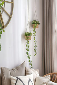 Transform your living space with these effortlessly chic living room wall decor ideas. Hanging plants in woven baskets add a touch of nature and serenity, perfect for creating a cozy and inviting atmosphere. Discover more inspiring home decor tips and tricks by viewing our article. Don't forget to follow us for your daily dose of home styling inspiration!