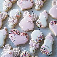 Sprinkled with Love!  Hand decorated in pink and white royal icing with sprinkle accents; these adorable cookies are the perfect treat for any baby shower or baby sprinkle party. Each 3"-4" cutout cookie is rolled to 3/8" thickness for the perfect cookie to icing ratio. Baked with the freshest ingredients these delicious vanilla, almond sugar cookies are sure to sweeten any day. BY THE DOZEN This listing includes ONE DOZEN (12) baked to order cookies individually packaged, heat sealed in certified food safe clear bags, then bubble wrapped and boxed for secure shipping. (3) Rompers  (3) Bottles (3) Rattles (3) Hearts Looking for something extra special?  Request a custom order here...  https://form.jotform.com/baketini/custom-cookie-request-form Food Allergy Warning: All goods produced by B