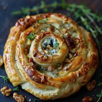 Delight your guests with our “Blue Cheese, Walnut, and Thyme Pull-Apart Puff Pastry Twirl” recipe. This savory treat features layers of flaky puff pastry filled with creamy blue cheese, crunchy walnuts, and fragrant thyme, creating a perfect blend of textures and flavors that’s sure to impress.