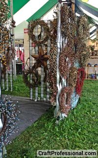 Wreaths displayed on gridwalls  film between slats