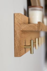 "This solid wood coat rack was created using rough sawn oak. It has been planed down, sanded and sealed with an oil based sealer. \"T\" style knobs have been placed under the shelf, perfect for keys, coats, towels, hats or scarfs. Keyhole plates are attached to the back. (Please note this shelf does not ship with any wall screws or anchors, please use whatever is appropriate for your wall.) 18\" Shelf has 3 \"T\" knobs. 24\" Shelf has 4 \"T\" knobs. 30\" and 34\" shelves have 5 \"T\" knobs. 40\"