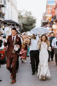 An epic traditional New Orleans wedding isn't complete without a second line parade! We took these wedding party photos in the French Quarter, right beside the couple's wedding venue, The Pharmacy Museum. Click through for the full wedding photo gallery. We offer fun and creative and unique wedding photos in New Orleans.